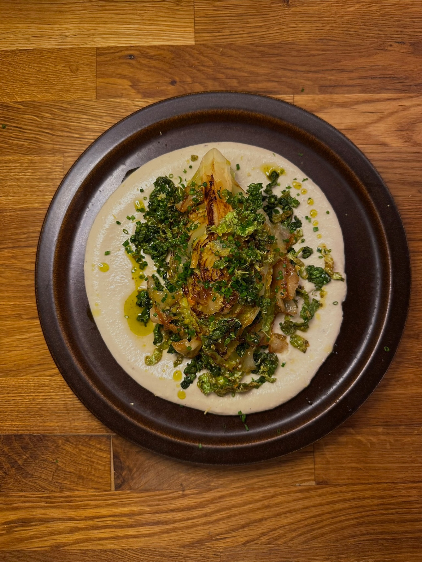Seared cabbage wedge on miso-cashew cream with crispy cabbage and chive oil